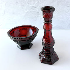 Vintage Avon 1876 Cape Cod Collection ruby red glass perfume bottle and candlestick holder with hexagonal base and ornate embossed pattern, shown with matching bowl r.