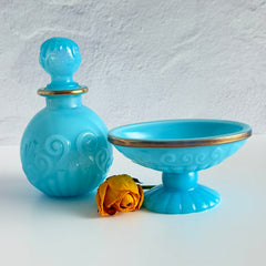 Vintage Avon turquoise opalite glass bottle and matching footed soap dish with gold‑tone trim.