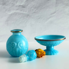 Vintage Avon turquoise opalite glass bottle and matching footed soap dish with gold‑tone trim.