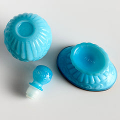 Vintage Avon turquoise opalite glass bottle and matching footed soap dish with gold‑tone trim.