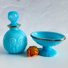 Vintage Avon turquoise opalite glass bottle and matching footed soap dish with gold‑tone trim.
