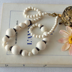Vintage Banana Republic cream Lucite bead necklace with blue glass bead rondelles and gold‑tone clasp, signed BR.