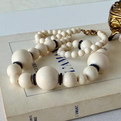 Vintage Banana Republic cream Lucite bead necklace with blue glass bead rondelles and gold‑tone clasp, signed BR.