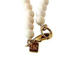 Vintage Banana Republic cream Lucite bead necklace with blue glass bead rondelles and gold‑tone clasp, signed BR.