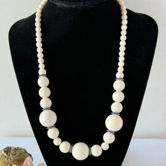 Vintage Banana Republic cream Lucite bead necklace with blue glass bead rondelles and gold‑tone clasp, signed BR.