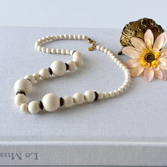 Vintage Banana Republic cream Lucite bead necklace with blue glass bead rondelles and gold‑tone clasp, signed BR.