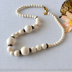 Vintage Banana Republic cream Lucite bead necklace with blue glass bead rondelles and gold‑tone clasp, signed BR.