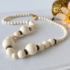 Vintage Banana Republic cream Lucite bead necklace with blue glass bead rondelles and gold‑tone clasp, signed BR.