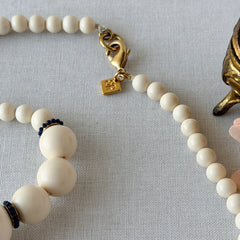 Vintage Banana Republic cream Lucite bead necklace with blue glass bead rondelles and gold‑tone clasp, signed BR.