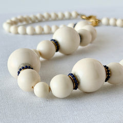 Vintage Banana Republic cream Lucite bead necklace with blue glass bead rondelles and gold‑tone clasp, signed BR.
