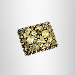 A vintage Barclay gold‑tone brooch set with jonquil rhinestones in mixed cuts, shown from various angles to display its shape, details, and condition.