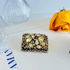 A vintage Barclay gold‑tone brooch set with jonquil rhinestones in mixed cuts, shown from various angles to display its shape, details, and condition.
