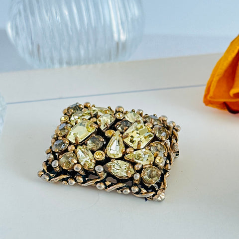 A vintage Barclay gold‑tone brooch set with jonquil rhinestones in mixed cuts, shown from various angles to display its shape, details, and condition.