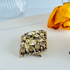 A vintage Barclay gold‑tone brooch set with jonquil rhinestones in mixed cuts, shown from various angles to display its shape, details, and condition.
