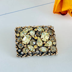 A vintage Barclay gold‑tone brooch set with jonquil rhinestones in mixed cuts, shown from various angles to display its shape, details, and condition.