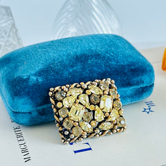 A vintage Barclay gold‑tone brooch set with jonquil rhinestones in mixed cuts, shown from various angles to display its shape, details, and condition.