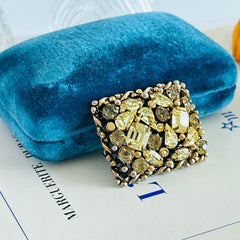 A vintage Barclay gold‑tone brooch set with jonquil rhinestones in mixed cuts, shown from various angles to display its shape, details, and condition.
