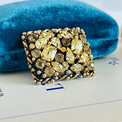 A vintage Barclay gold‑tone brooch set with jonquil rhinestones in mixed cuts, shown from various angles to display its shape, details, and condition.