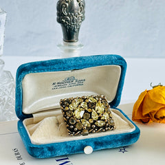 A vintage Barclay gold‑tone brooch set with jonquil rhinestones in mixed cuts, shown from various angles to display its shape, details, and condition.
