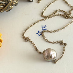 Vintage gold‑filled necklace with a beige baroque pearl pendant.