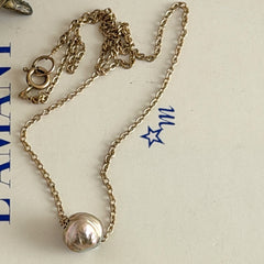 Vintage gold‑filled necklace with a beige baroque pearl pendant.