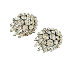 Vintage clear rhinestone clip‑on earrings with teardrop and chaton stones in a mid‑century silver tone fan‑cluster design.