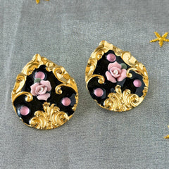 Vintage 1980s teardrop post earrings with 3D pink polymer clay rose, black enamel base, and gold tone pressed metal scrollwork on original card.