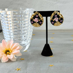 Vintage 1980s teardrop post earrings with 3D pink polymer clay rose, black enamel base, and gold tone pressed metal scrollwork on original card.