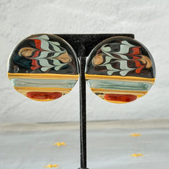 Vintage 1980s black, green, and rust enamel geometric gold‑tone circle post earrings on original Complements card, shown on grey fabric background.