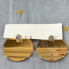 Vintage 1980s black, green, and rust enamel geometric gold‑tone circle post earrings on original Complements card, shown on grey fabric background.