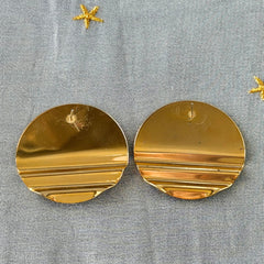Vintage 1980s black, green, and rust enamel geometric gold‑tone circle post earrings on original Complements card, shown on grey fabric background.