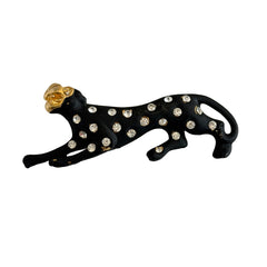 Black matte enamel panther brooch with clear rhinestones and gold tone accents, vintage 1990s animal jewelry.