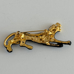 Black matte enamel panther brooch with clear rhinestones and gold tone accents, vintage 1990s animal jewelry.