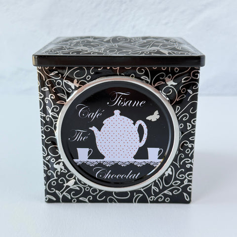 French black matelassé metal tea cube tin with silver accents and a pink teapot motif by Moldeo