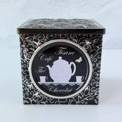 French black matelassé metal tea cube tin with silver accents and a pink teapot motif by Moldeo