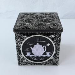 French black matelassé metal tea cube tin with silver accents and a pink teapot motif by Moldeo