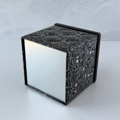 French black matelassé metal tea cube tin with silver accents and a pink teapot motif by Moldeo