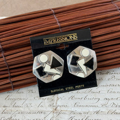 Vintage 1980s black and white enamel geometric hexagonal post earrings with silver tone and abstract motifs, with on original Impressions card.