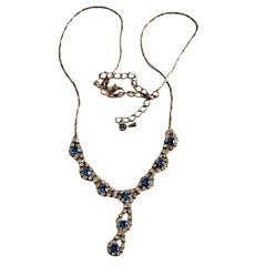 Vintage silver‑tone necklace with a delicate blue and clear rhinestone drop pendant on an adjustable chain.