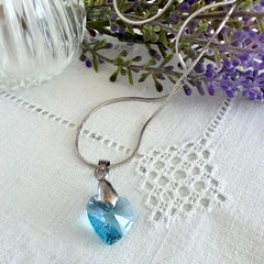 Vintage light blue faceted crystal heart pendant on a silver tone chain, 1990s French necklace.