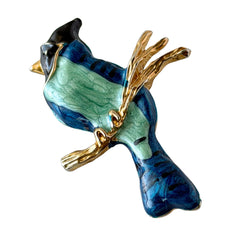 Vintage blue and green enamel gold‑tone bird brooch perched on a branch, shown from multiple angles.