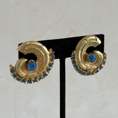 Vintage 1980s textured gold tone spiral clip-on earrings with blue rhinestones.