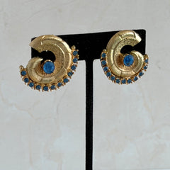 Vintage 1980s textured gold tone spiral clip-on earrings with blue rhinestones.
