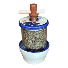 Provence ceramic herb mill with hand-painted blue lavender sprigs and green leaves on a cream base, featuring a glass chamber filled with dried herbs and a wooden crossbar handle for grinding.