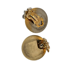 Pair of vintage Marcel Boucher gold‑tone disk clip‑on earrings with ruby‑red baguette rhinestones and clear rhinestone accents.