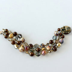 Vintage 3‑strand bracelet with Aurum and Vitrail crystal beads, faux jasper art glass beads, and shiny brown beads in gold tone