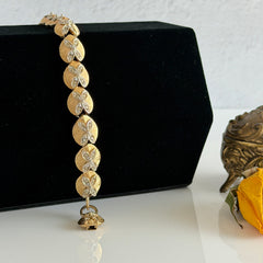 Vintage gold tone bracelet with textured links and pavé rhinestone floral accents