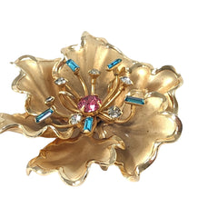 Vintage Bugbee & Niles brushed gold tone flower brooch with pink, aqua, and clear rhinestones, shown from multiple angles to highlight its dimensional petals and detailed construction.