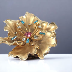 Vintage Bugbee & Niles brushed gold tone flower brooch with pink, aqua, and clear rhinestones, shown from multiple angles to highlight its dimensional petals and detailed construction.