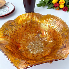 Vintage Imperial Glass marigold carnival bowl with Lustre Rose pattern, iridescent finish, scalloped edge, and three-footed base.